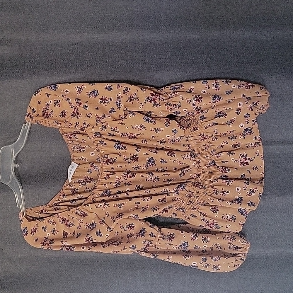 CBRAND blouse burnt orange background with red, blue, and white.